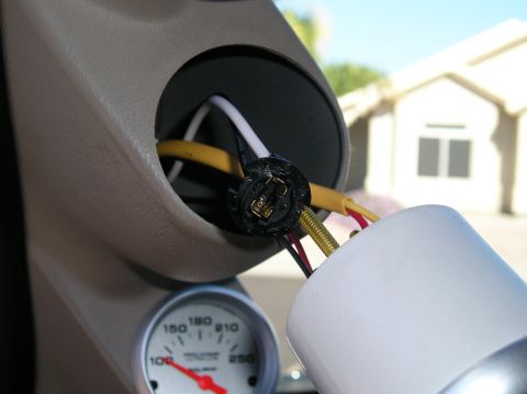 2001 Ford F-350 - Close-up of a vehicle's interior gauge cluster showing wiring and a partially installed gauge.