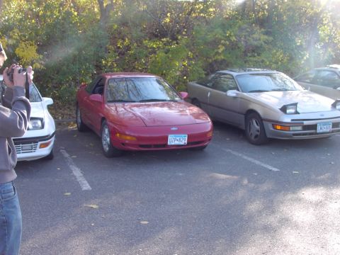1991 Ford Probe - Two Ford Probes are parked side-by-side in a parking lot on a sunny day.