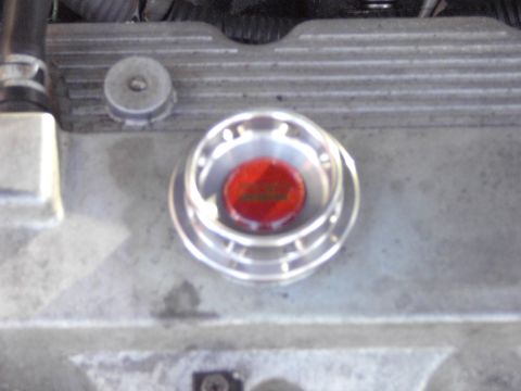 1991 Ford Probe - Close-up of an engine component with a red cap and silver detailing.