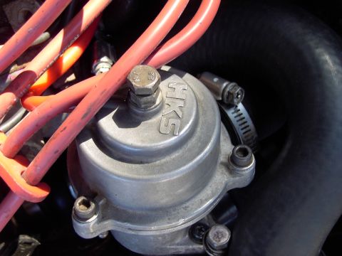 1991 Ford Probe - A silver HKS engine component is visible with red wires and a metal hose clamp attached.