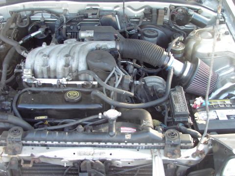 1991 Ford Probe - Close-up view of a car's engine bay, showing various components and wiring.