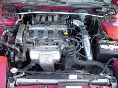 1991 Ford Probe - The engine bay of a car, showing the engine, battery, and various hoses and wires.