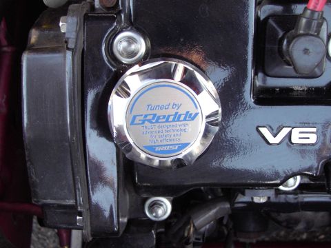 1991 Ford Probe - Close-up of an engine component a V6 badge and a GReddy branded oil cap.