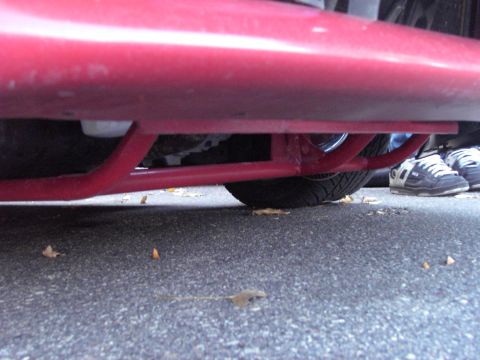 1991 Ford Probe - Undercarriage view of a red vehicle, showing structural components and a tire. Text from Supermotors.net is visible at the bottom right.