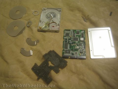 1968 Ford Mustang - Components of a disassembled hard drive are laid out on a textured surface.