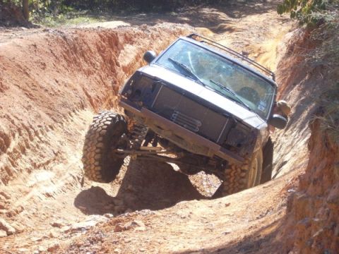 1992 Ford Bronco - This 1992 Ford Bronco tackles a challenging off-road trail, demonstrating its capabilities.