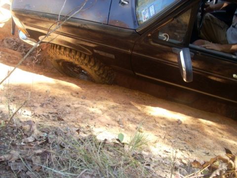 1992 Ford Bronco - This 1992 Ford Bronco is stuck in the mud, with its front tire partially submerged.