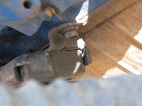 1983 Ford F-250 - Broken engine mount bracket detail, showing metal fatigue and damage.