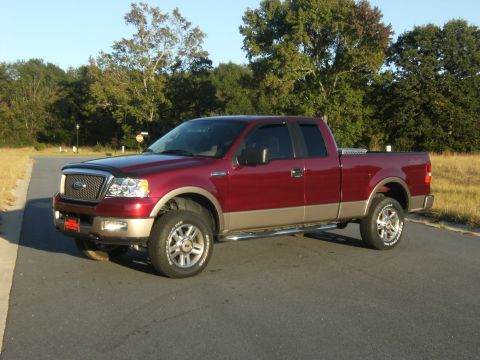 2005 Ford F-150 - This red Ford F-150 pickup truck is shown from a 3/4 front angle on a sunny day.