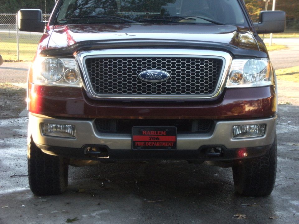 Front view of a red 2005 Ford F-150 with a Harlem Fire Department license plate