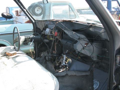 1983 Ford F-250 - Interior of a disassembled light blue pickup truck, with exposed wiring and steering column visible.