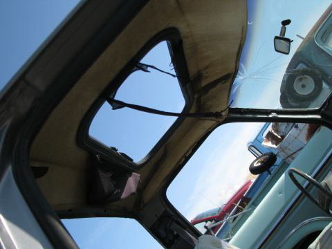 1983 Ford F-250 - Looking up through the sunroof and cracked windshield reveals the sky and another vehicle.
