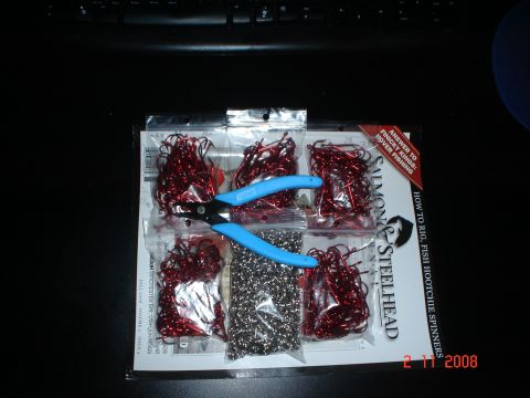 1990 Ford Bronco - A fishing tackle kit containing red hooks, beads, and blue pliers is displayed on a dark surface.