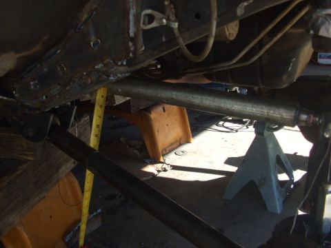 1994 Jeep Cherokee - Close-up view of vehicle undercarriage, focusing on suspension components and a tape measure for scale.