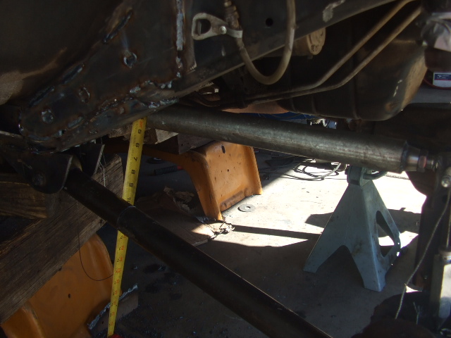 Underbody of vehicle with tape measure showing suspension modification
