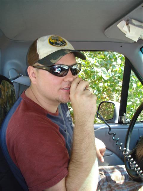 2008 International School Bus - A man is seen inside the cabin of a vehicle, holding a radio to his mouth.