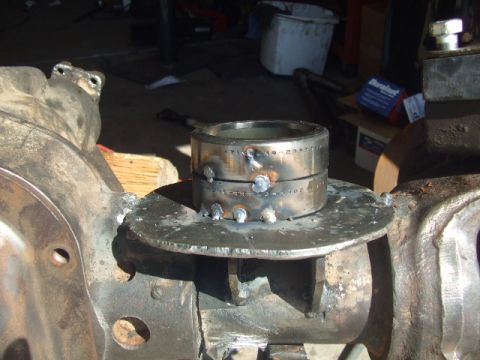 1994 Jeep Cherokee - Close-up of a metal ring welded onto a vehicle's axle housing, showing signs of modification and repair.