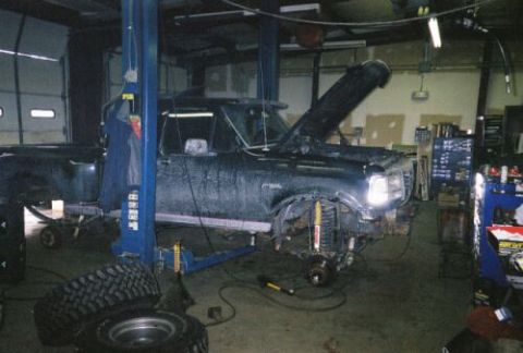 1994 Ford F-150 - This 1994 Ford F-150 is undergoing front suspension work in a garage.
