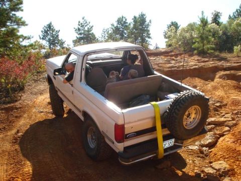 2008 International School Bus - This white Ford Bronco navigates a rough dirt path, with occupants enjoying the off-road adventure.