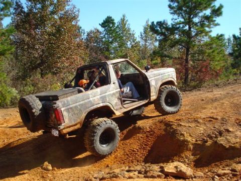 2008 International School Bus - Off-road vehicle navigating a challenging dirt trail with steep inclines.