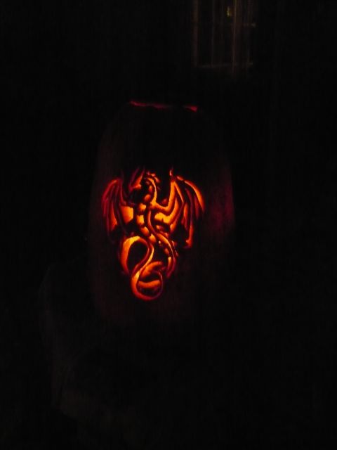 1993 Ford Probe - A pumpkin carved with a dragon design is illuminated from within.