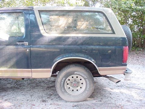 1994 Ford Bronco - The side profile of a Ford Bronco, with a spare tire mounted on the rear.