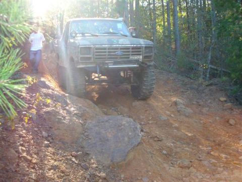 2008 International School Bus - This Ford F-Series truck is shown off-roading on a steep, rocky trail.