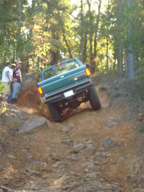 2008 International School Bus - Pickup truck navigating a challenging off-road trail.