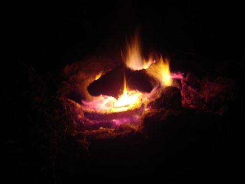 2008 International School Bus - Campfire burning at night.