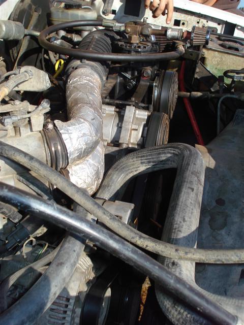 2008 International School Bus - Close-up view of an engine bay, showing various hoses, belts, and engine components.
