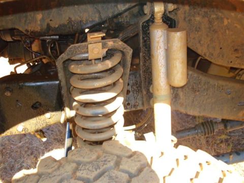 2008 International School Bus - The front suspension system of a vehicle, including a coil spring and shock absorber, is visible in this close-up shot.