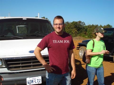 2008 International School Bus - A white van and a black Jeep are parked outdoors under a clear blue sky.