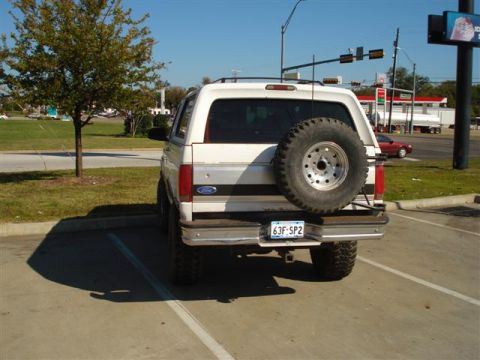 2008 International School Bus - Rear view of a white Ford Bronco, showing its spare tire and license plate.