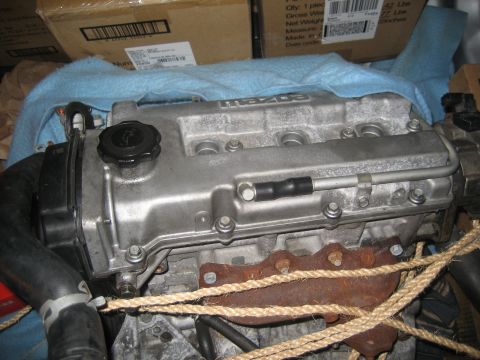 1993 Ford Probe - A close-up view of a Mazda engine, partially covered with a blue cloth.