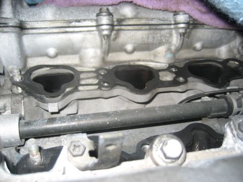 1993 Ford Probe - Close-up of an engine intake manifold gasket, showing the mating surfaces.
