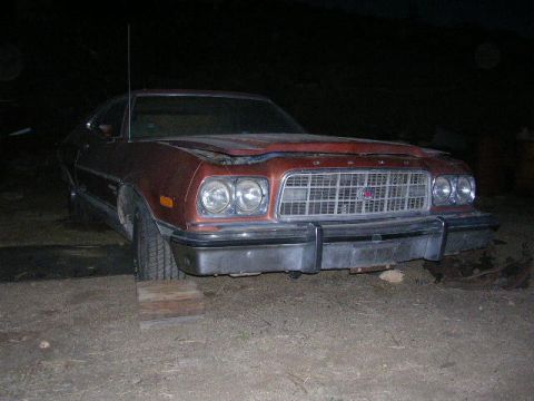 1975 Ford Ranchero - This 1975 Ford Ranchero is parked outside with its hood open.