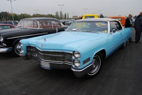 1991 Ford Crown Victoria - A light blue convertible is parked at an outdoor event with other cars and people around.