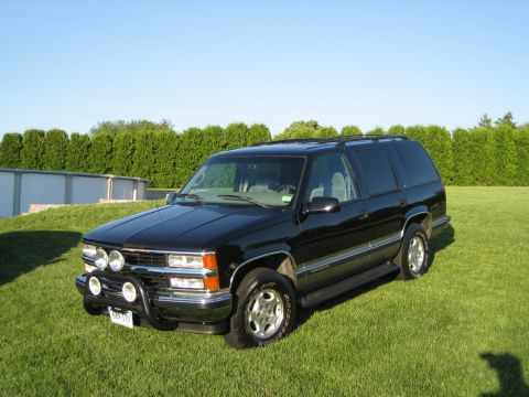 1998 Chevrolet Tahoe - This 1998 Chevrolet Tahoe is presented in a three-quarter front view, its black exterior and added bull bar with fog lights.