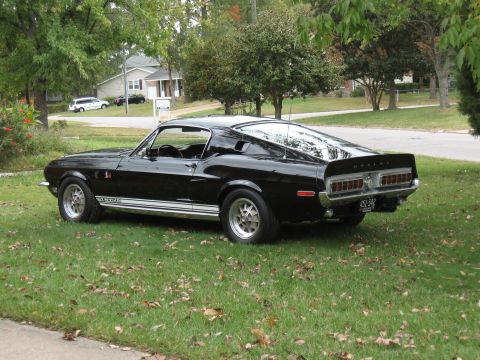1968 Shelby GT500 - This 1968 Shelby GT500 is captured in a three-quarter front view, its iconic design and Shelby badging.