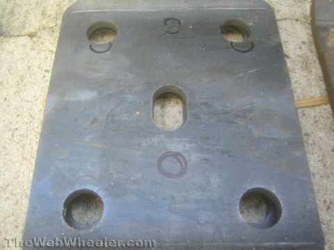 1987 Suzuki Samurai - A metal plate with multiple drilled holes, likely a custom automotive part.