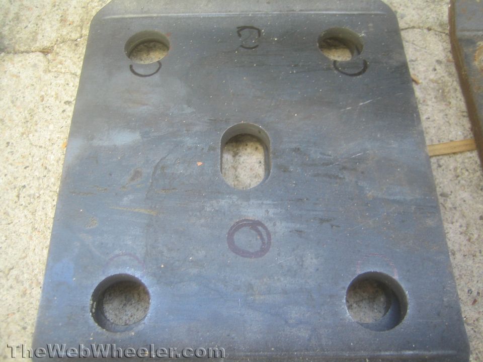 Metal plate with four large holes and one central oblong hole