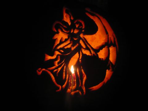 1993 Ford Probe - A carved pumpkin glows from within, casting an eerie light in the darkness.