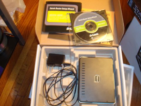 1977 Ford F-100 - A D-Link router is shown with its power adapter and Quick Router Setup Wizard CD.