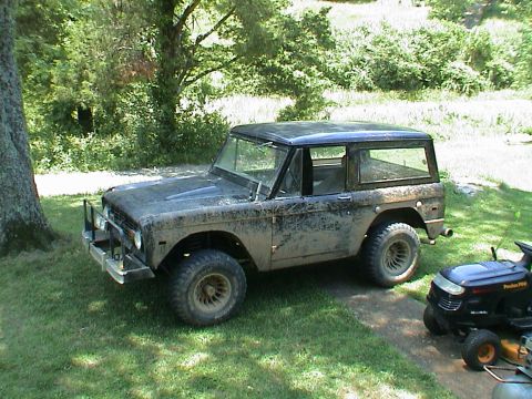 1972 Ford Bronco - This first-generation Ford Bronco is covered in dirt and parked in a grassy area.
