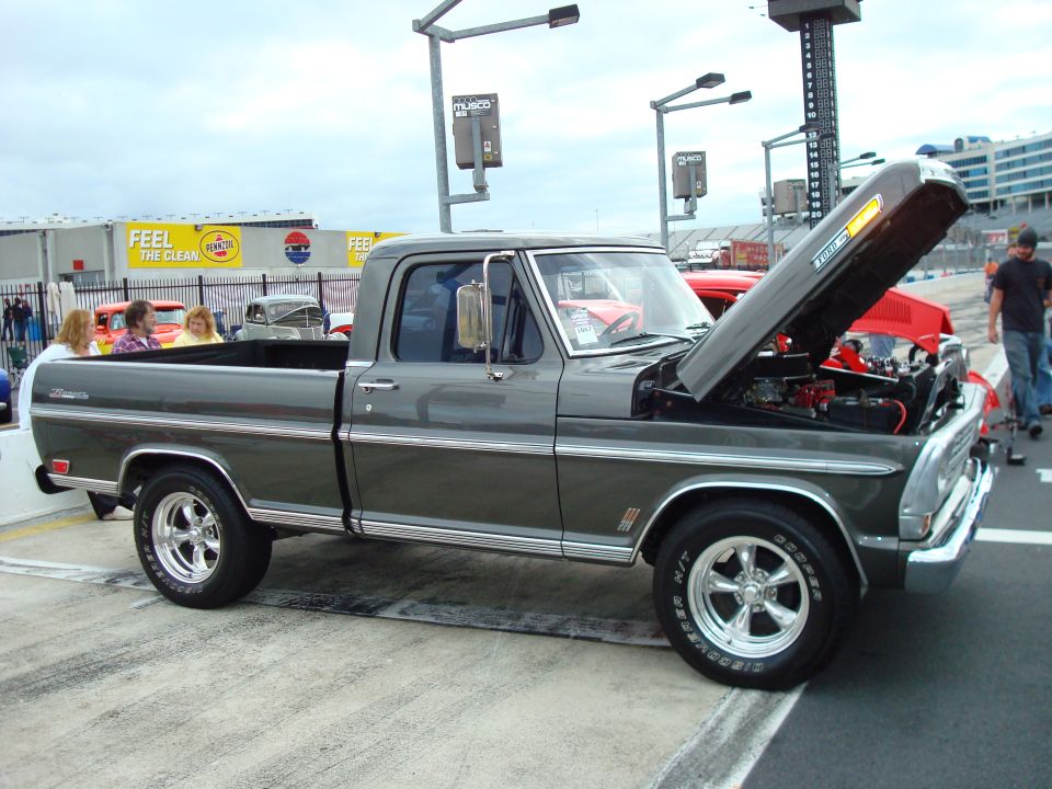 Gray 1970s Ford F-Series pickup truck with hood open, parked outdoors