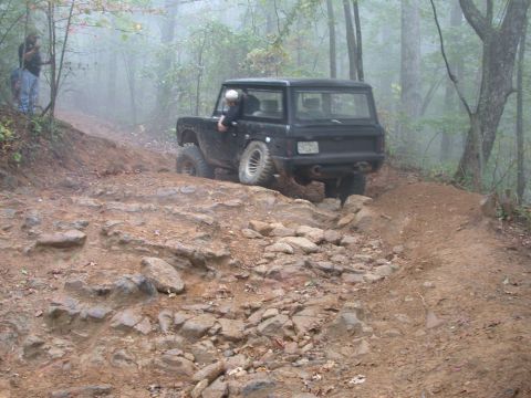 1972 Ford Bronco - Black 1972 Ford Bronco navigates a challenging rocky off-road path.
