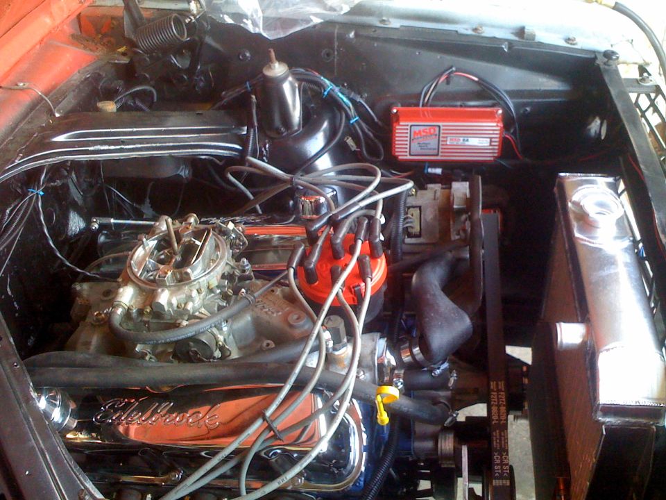 Engine bay with a V8 engine, Edelbrock intake, and MSD ignition box. Radiator is visible on the right