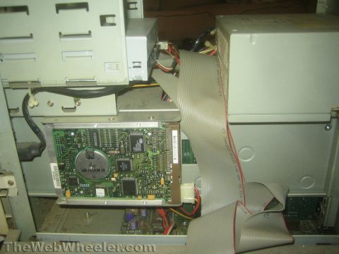 1968 Ford Mustang - The internal components of a computer, including a circuit board and ribbon cable, are visible.