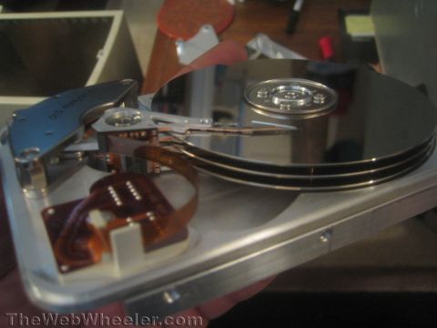 1968 Ford Mustang - A hard disk drive is shown with its internal components exposed.
