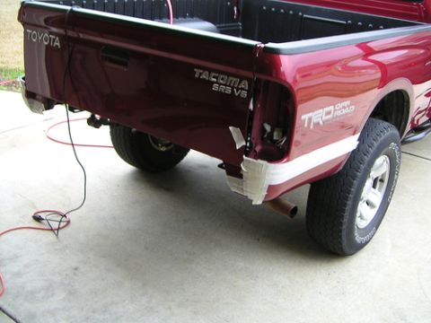 1996 Ford F-150 - Rear view of a Toyota Tacoma pickup truck with visible TRD Off Road decals.